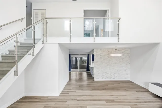 a view of kitchen living room with cabinets and stainless steel appliances