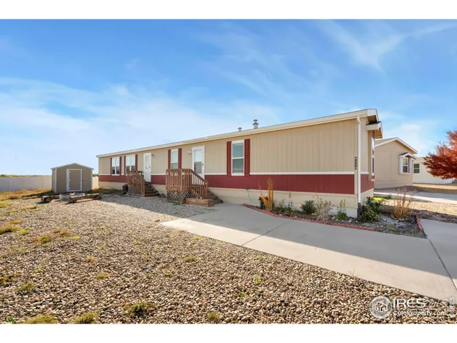 a view of a dirt road and building