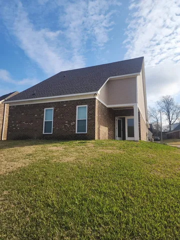 a front view of a house with a garden