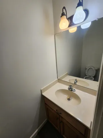 a bathroom with a sink vanity and a mirror