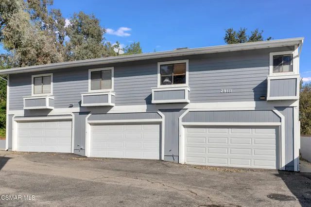 a view of a chairs and table in the backyard