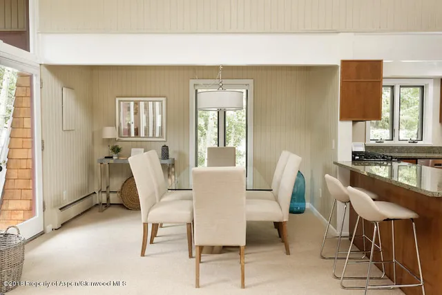 a dining room with furniture and window