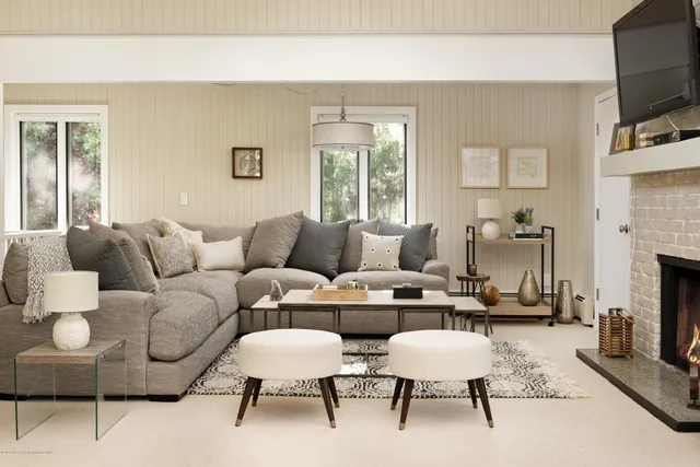 a living room with furniture fireplace and flat screen tv