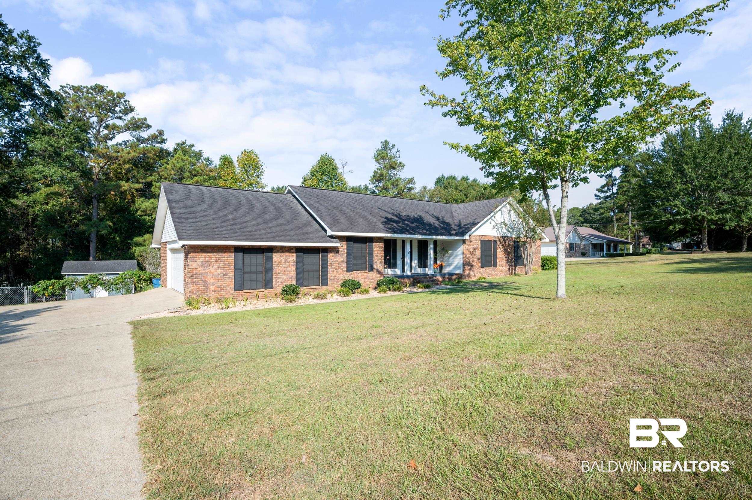 550 Norwood Road Monroeville, AL 36460 - Photo 45 of 46 Single story home featuring a porch, a front yard, brick siding, and roof with shingles