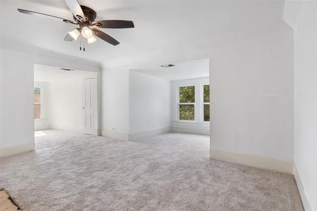a view of empty room with a ceiling fan