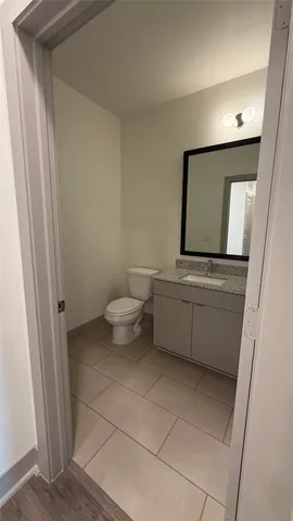 a bathroom with a sink a toilet and mirror