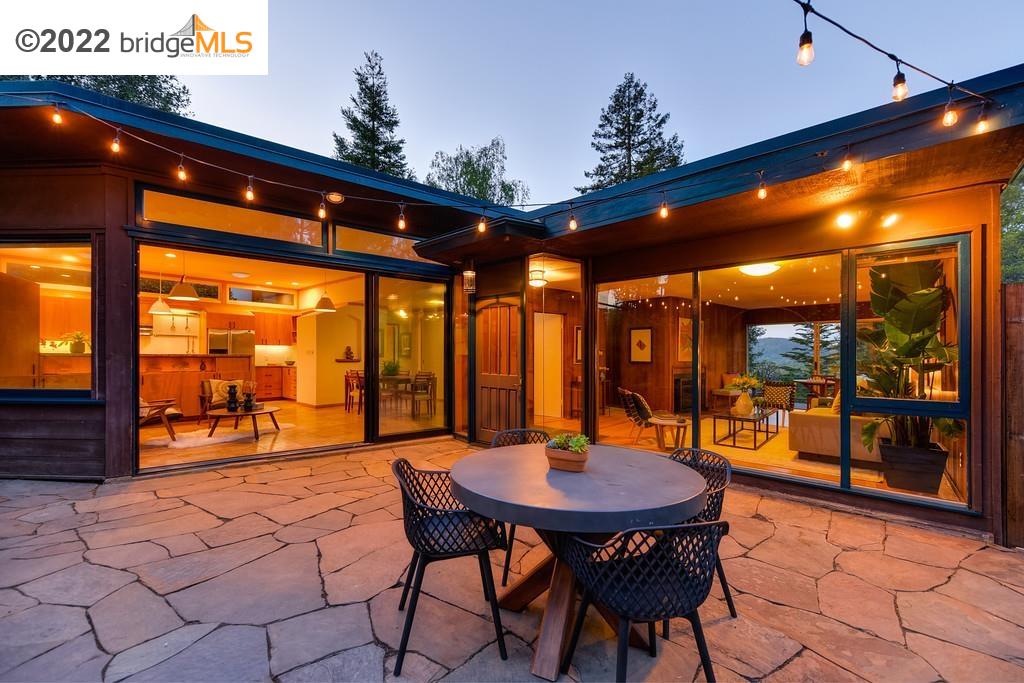 a view of a patio with a table and chairs and potted plants