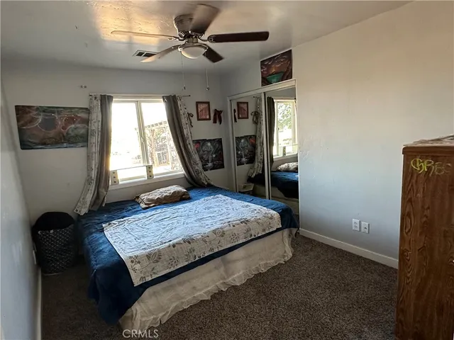 a bedroom with a bed and window