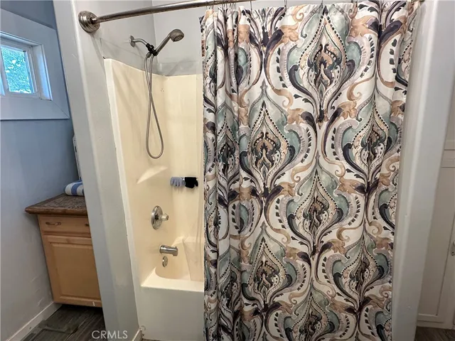 a bathroom with a shower curtain and a sink