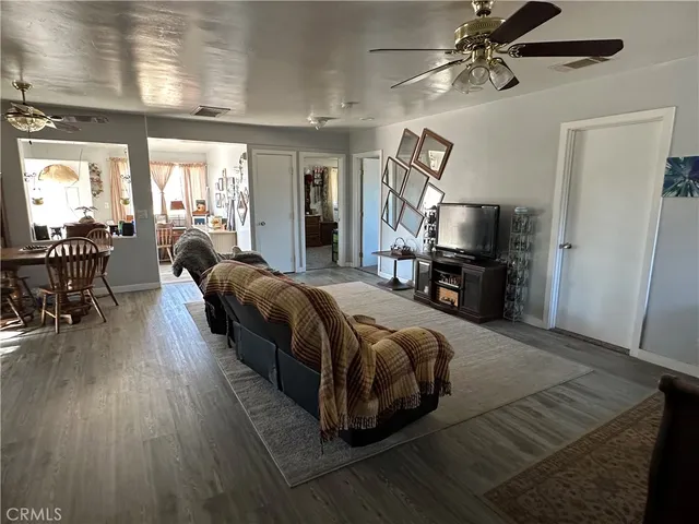 a spacious bedroom with a bed couch table and flat screen tv