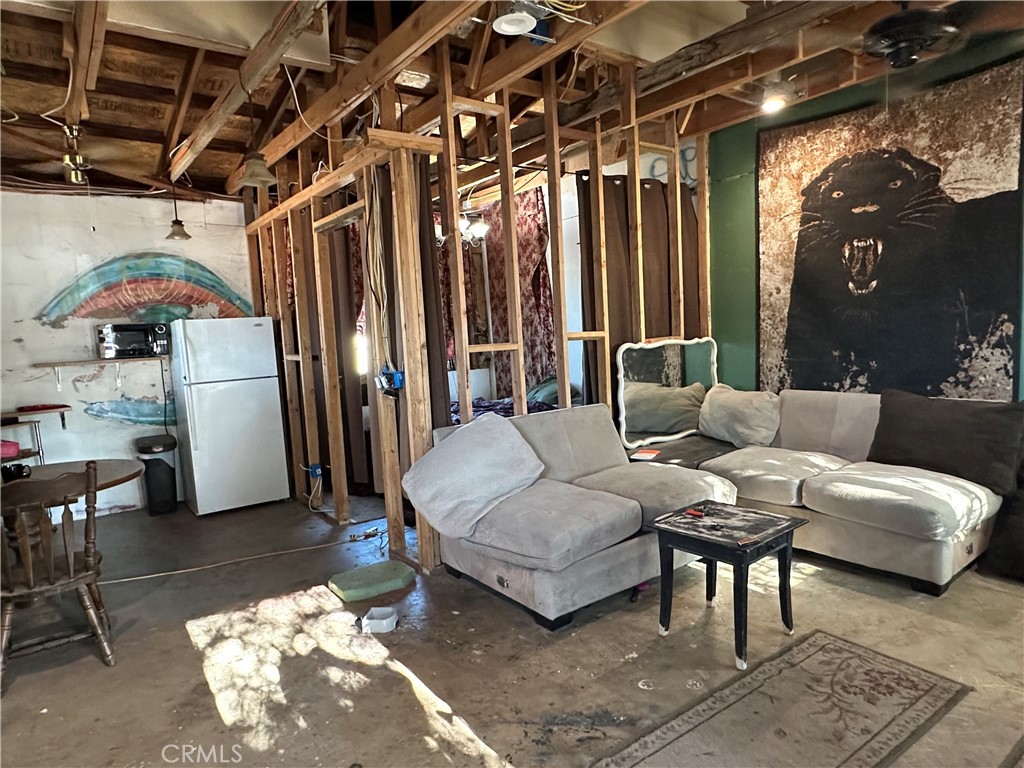 8625 C Avenue Hesperia, CA 92345 - Photo 22 of 29 a living room with furniture and a chandelier