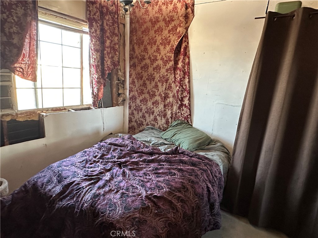 8625 C Avenue Hesperia, CA 92345 - Photo 23 of 29 a bed sitting in a bedroom next to a window