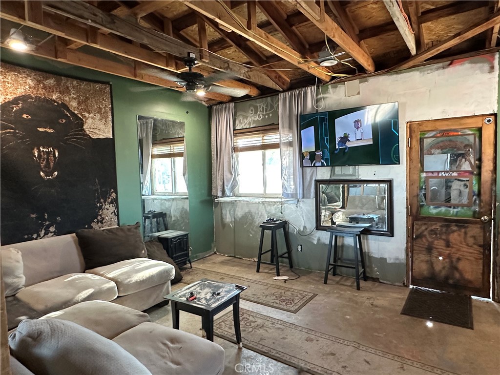 8625 C Avenue Hesperia, CA 92345 - Photo 24 of 29 a living room with furniture and a window