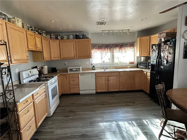 a kitchen with a sink cabinets and window