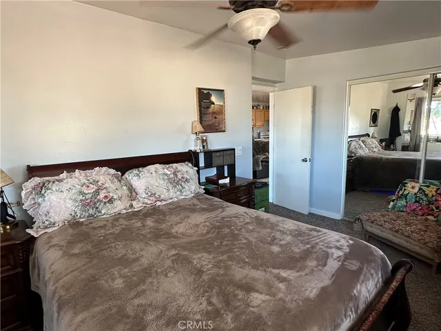 a large bed sitting in a bedroom and chandelier