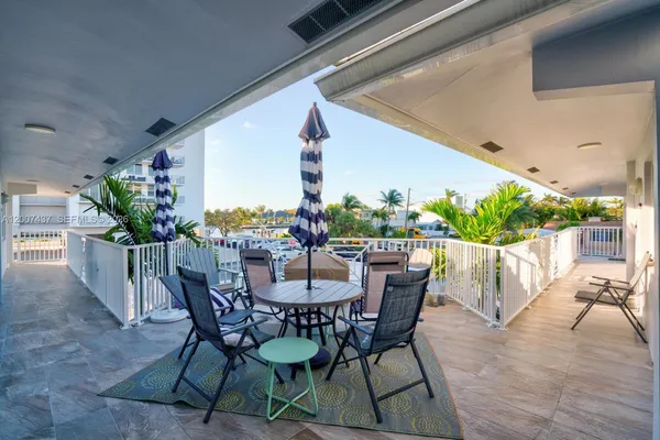 a view of an outdoor dining space with a table and chairs