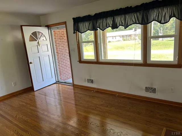 a view of an entryway with wooden floor