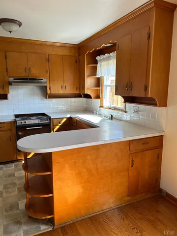 a kitchen with stainless steel appliances granite countertop a sink and a microwave