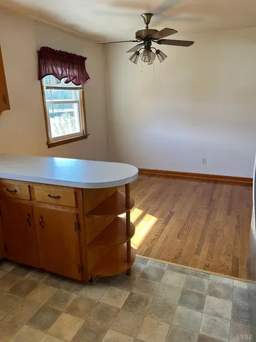 a view of empty room with wooden floor and fireplace