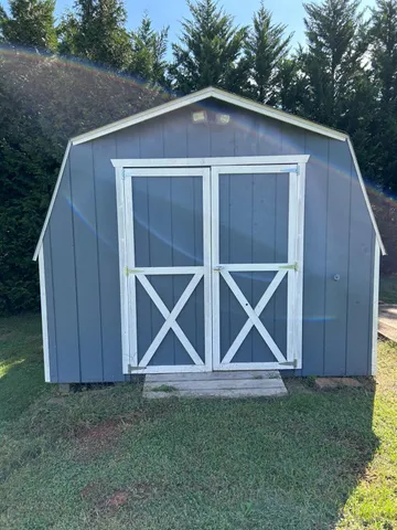 a backyard of a house with wooden fence