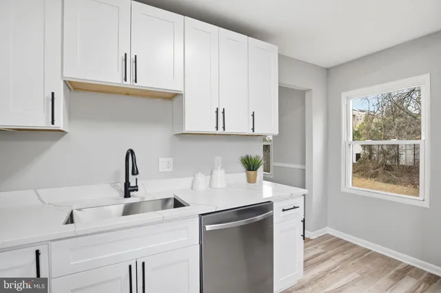a kitchen with appliances cabinets and a window