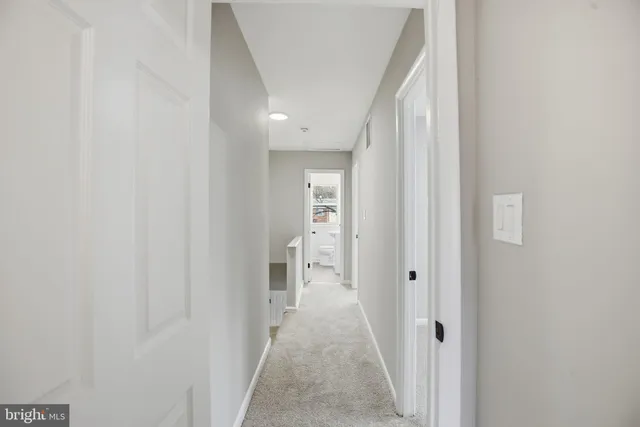 a view of a hallway with wooden shelves