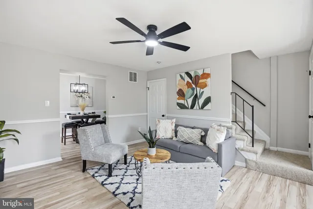 a living room with furniture and wall paintings