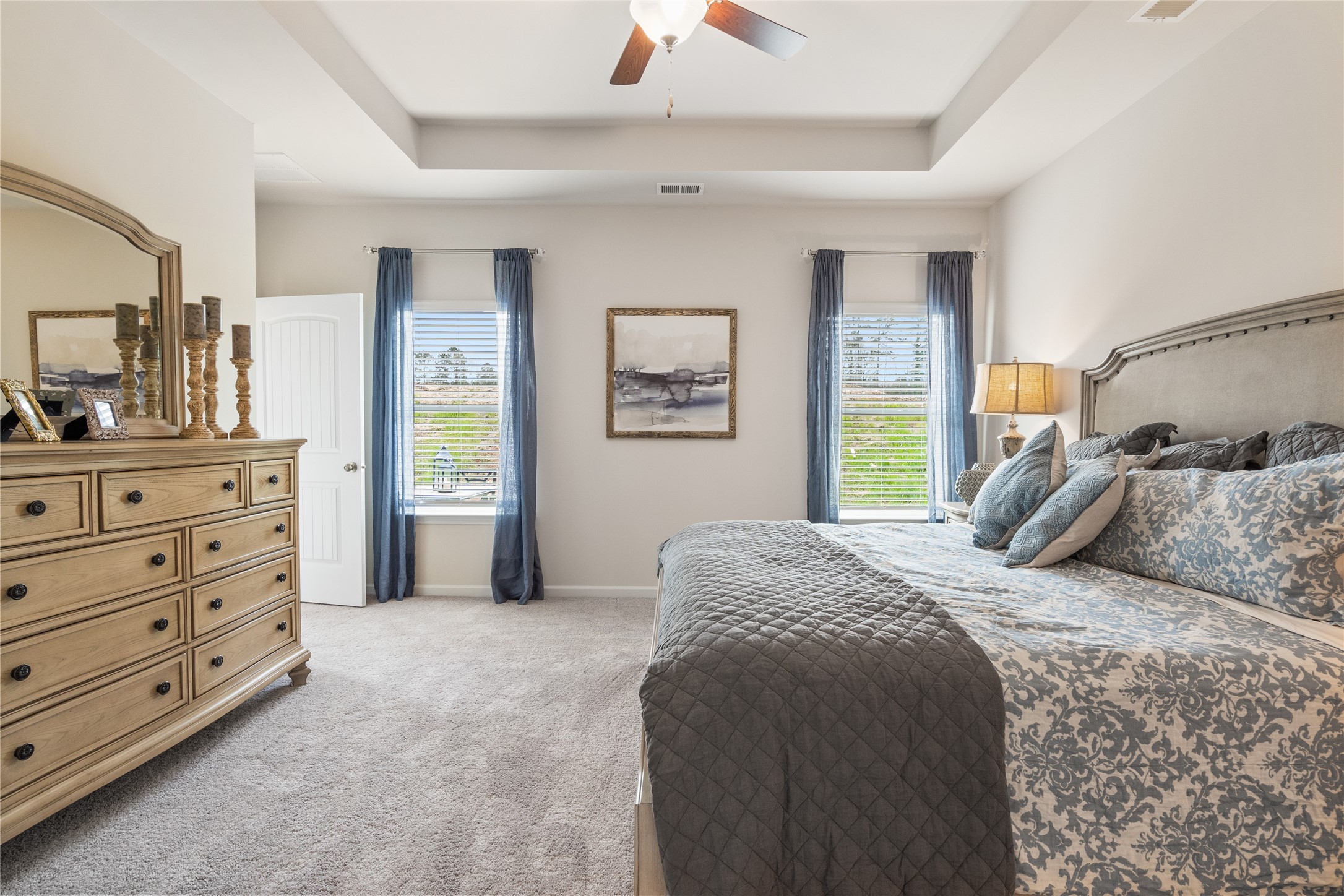 9722 Enclave Ridge Road Willis, TX 77318 - Photo 13 of 20 a bedroom with a bed and a dresser