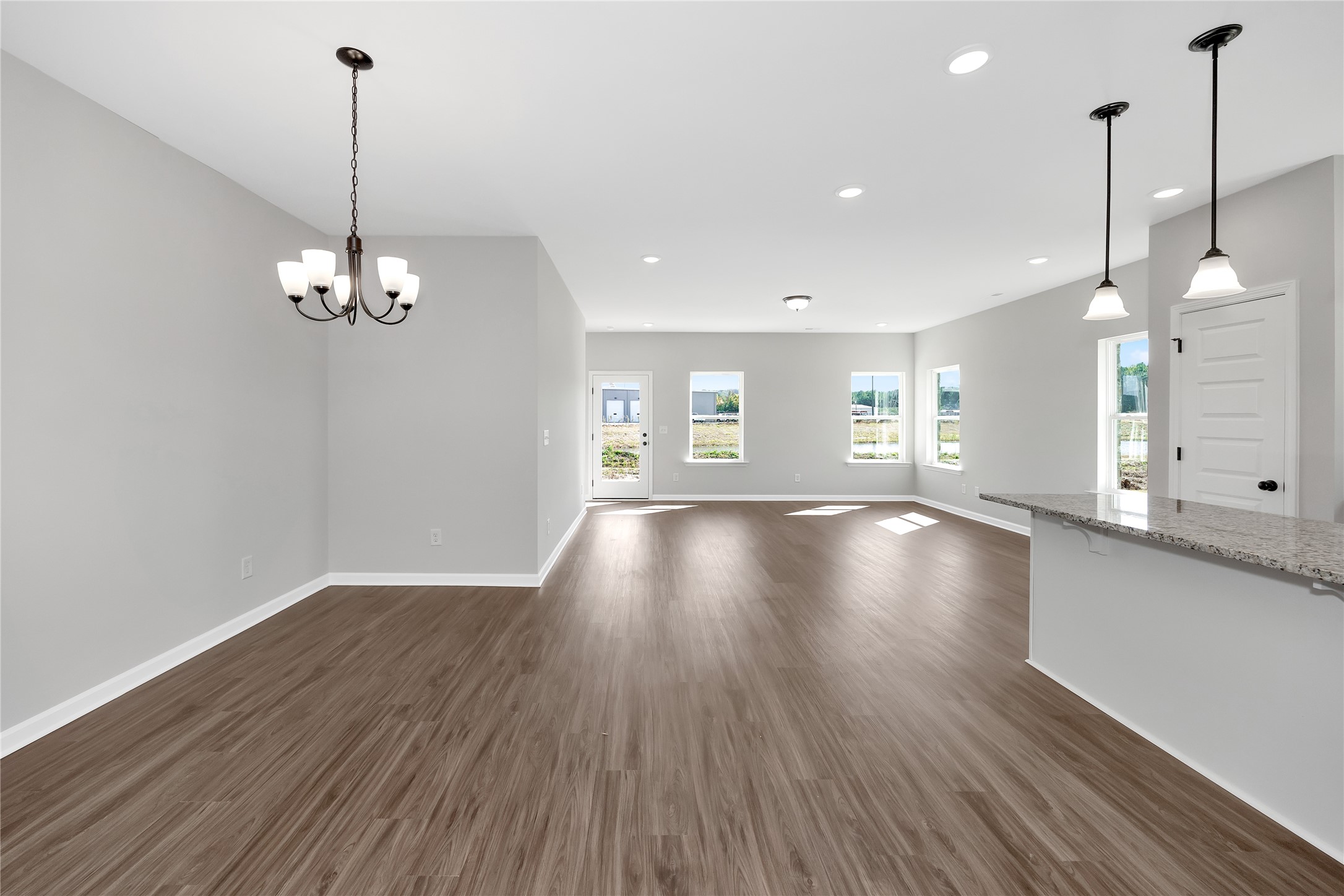 9722 Enclave Ridge Road Willis, TX 77318 - Photo 3 of 20 a view of a room with wooden floor and large windows