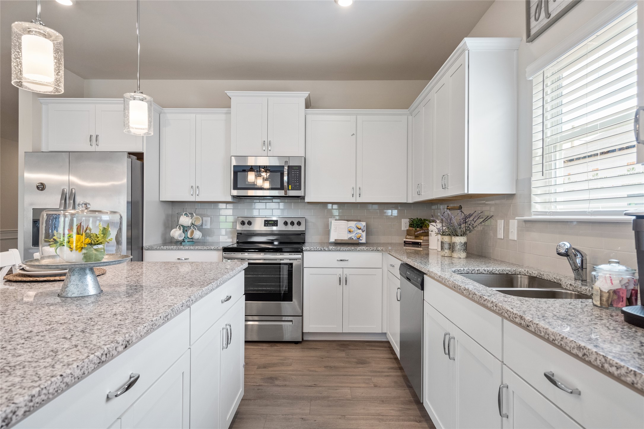 9722 Enclave Ridge Road Willis, TX 77318 - Photo 6 of 20 a kitchen with stainless steel appliances granite countertop a sink a stove top oven a counter space and cabinets