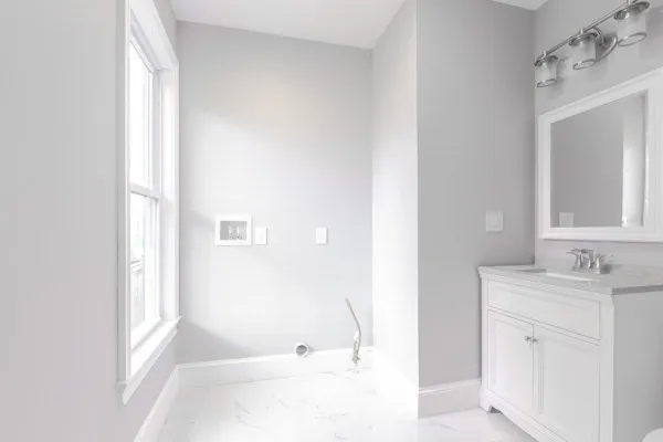 a bathroom with a tub sink and mirror