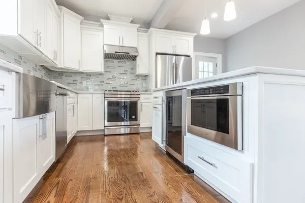 a kitchen with stainless steel appliances granite countertop a stove and a refrigerator