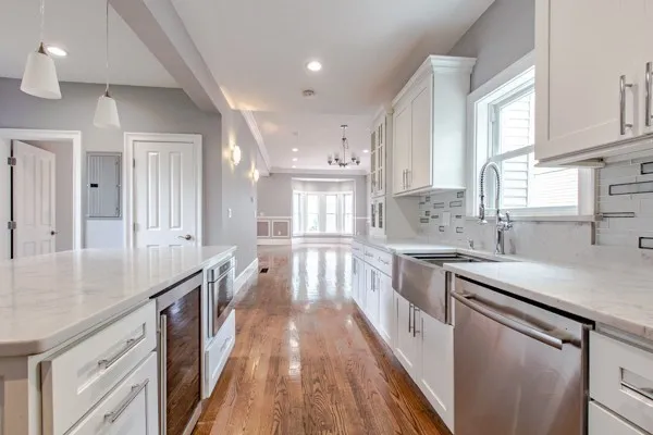 a kitchen with granite countertop a sink stove refrigerator and cabinets