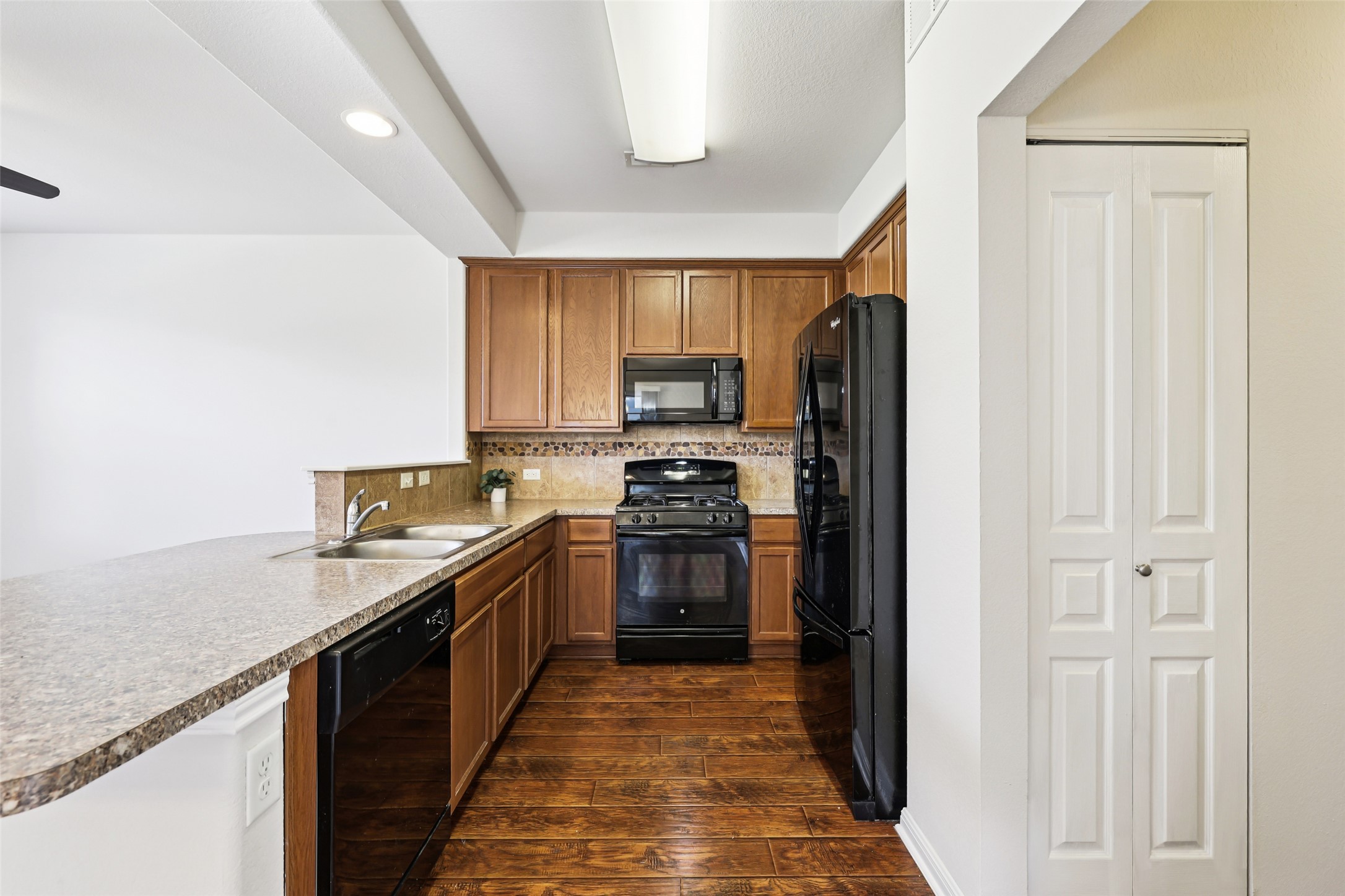 1524 Sanders Kyle, TX 78640 - Photo 11 of 37 a kitchen with granite countertop a refrigerator stove and oven
