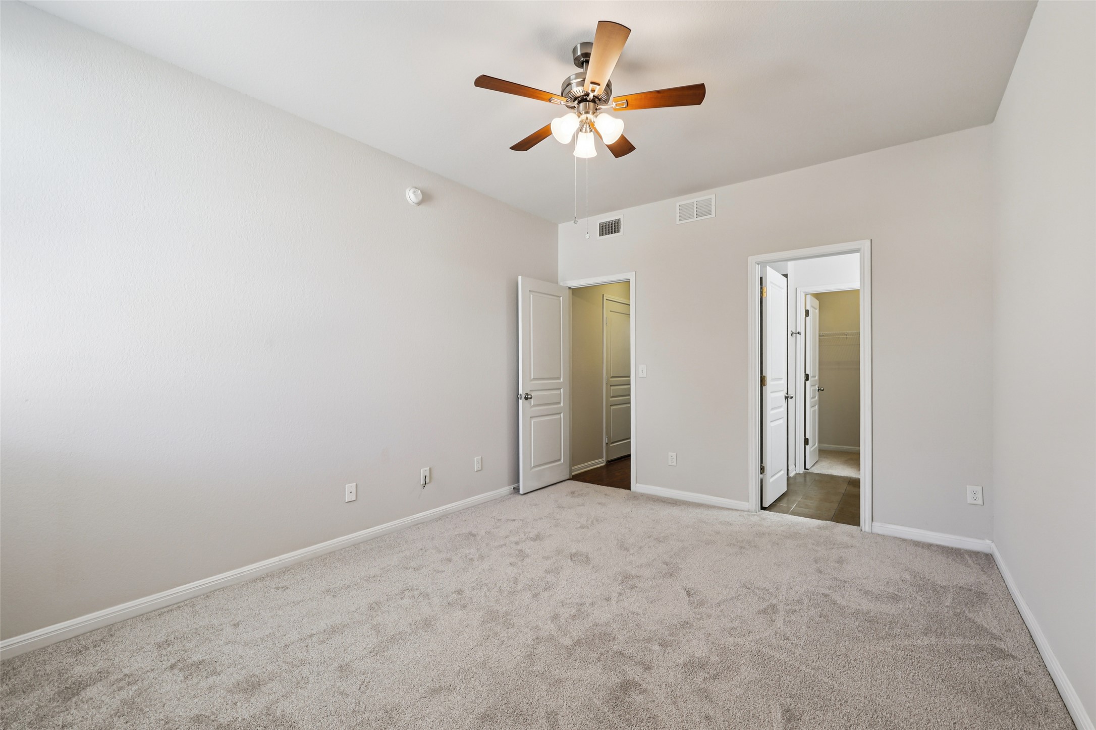 1524 Sanders Kyle, TX 78640 - Photo 14 of 37 an empty room with closet and a chandelier fan