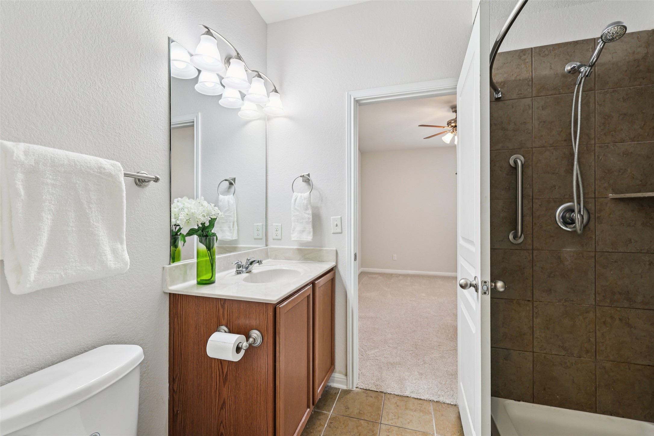 1524 Sanders Kyle, TX 78640 - Photo 19 of 37 a bathroom with a granite countertop sink a toilet and shower