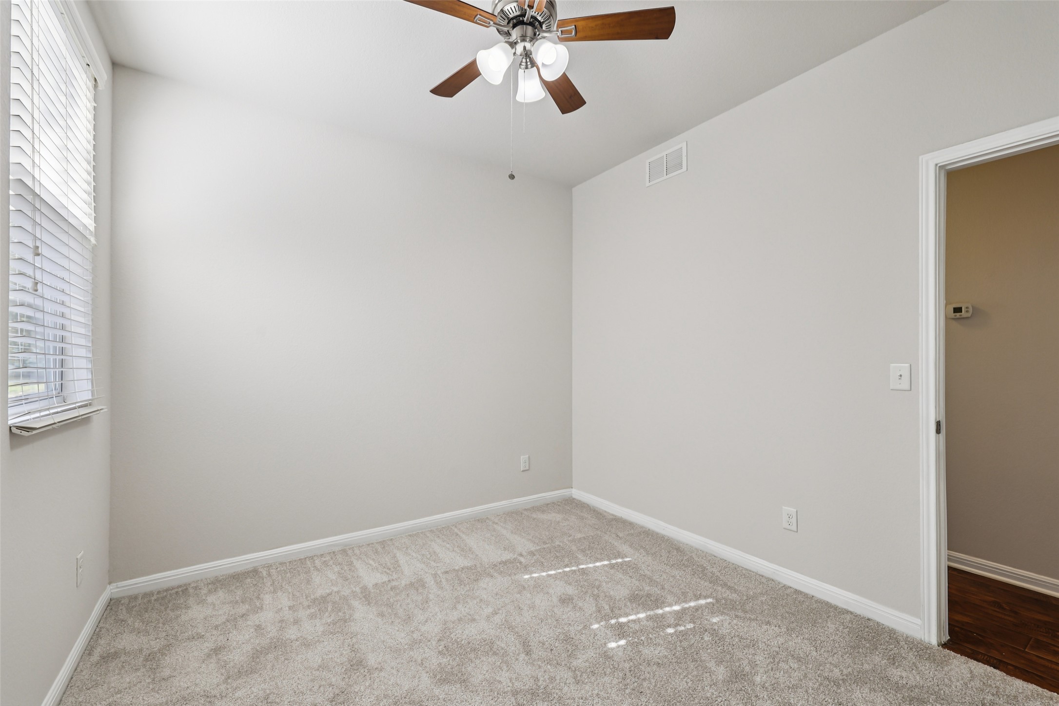1524 Sanders Kyle, TX 78640 - Photo 22 of 37 an empty room with a window and a fan