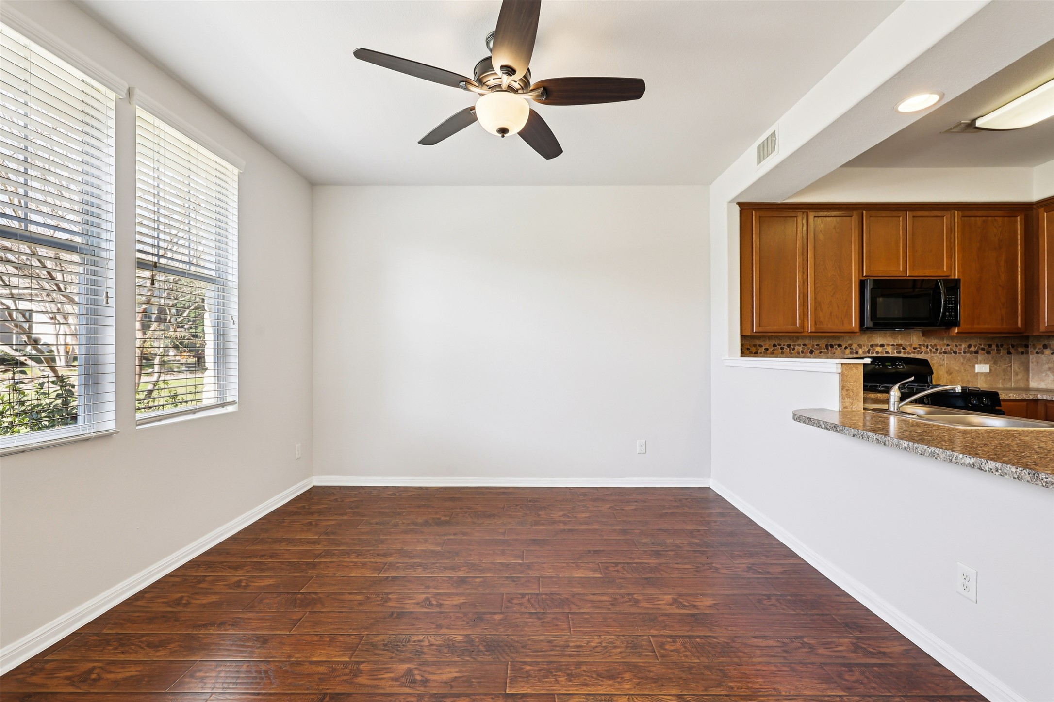 1524 Sanders Kyle, TX 78640 - Photo 35 of 37 a view of a kitchen with wooden floor and a window