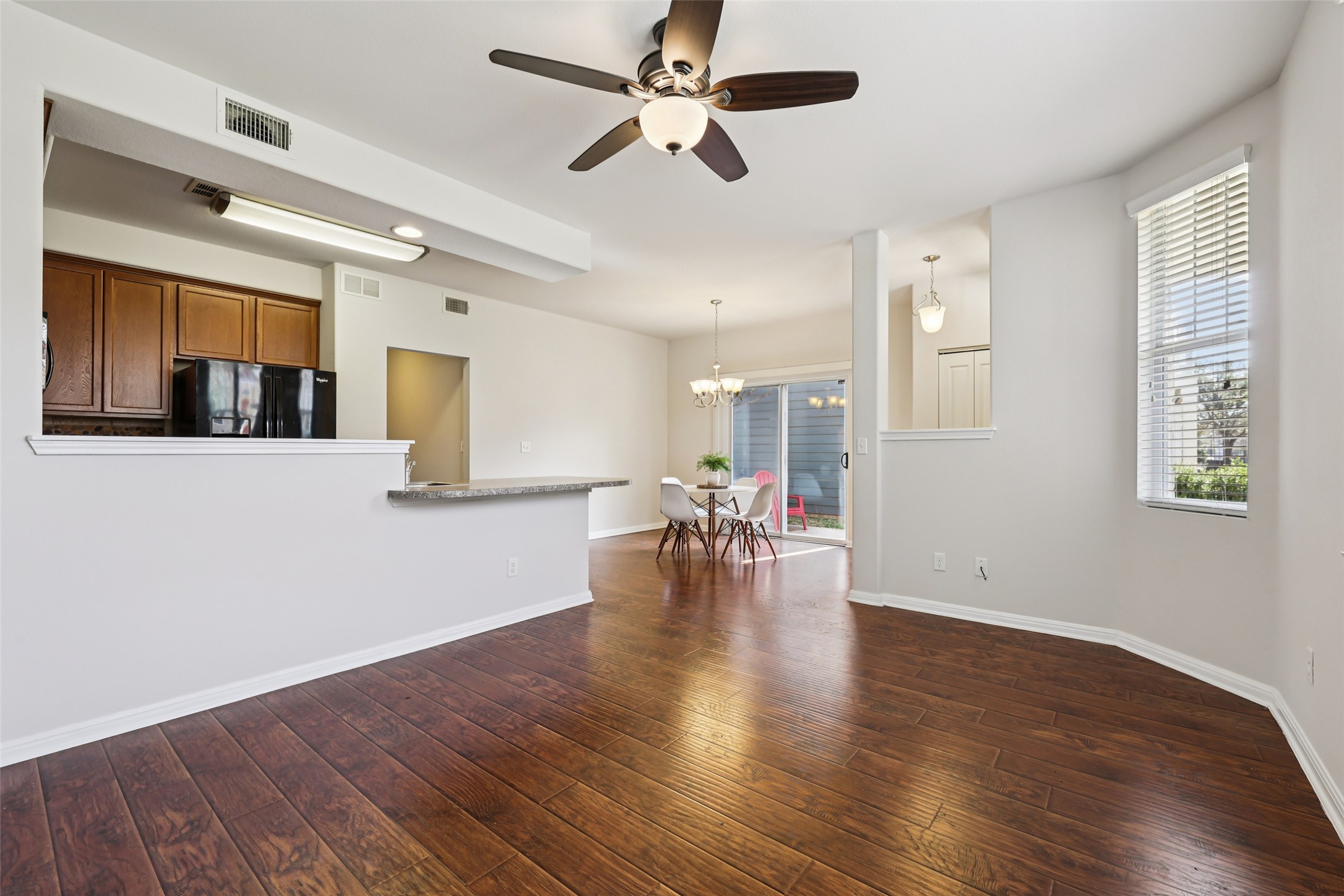 1524 Sanders Kyle, TX 78640 - Photo 6 of 37 a view of a livingroom with wooden floor and a ceiling fan