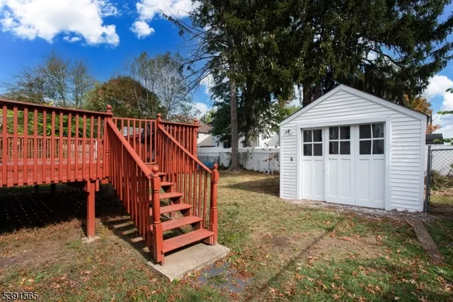 a view of a house with a wooden deck