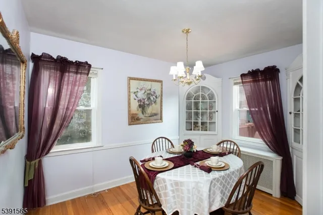 a view of a dining room with furniture wooden floor and chandelier