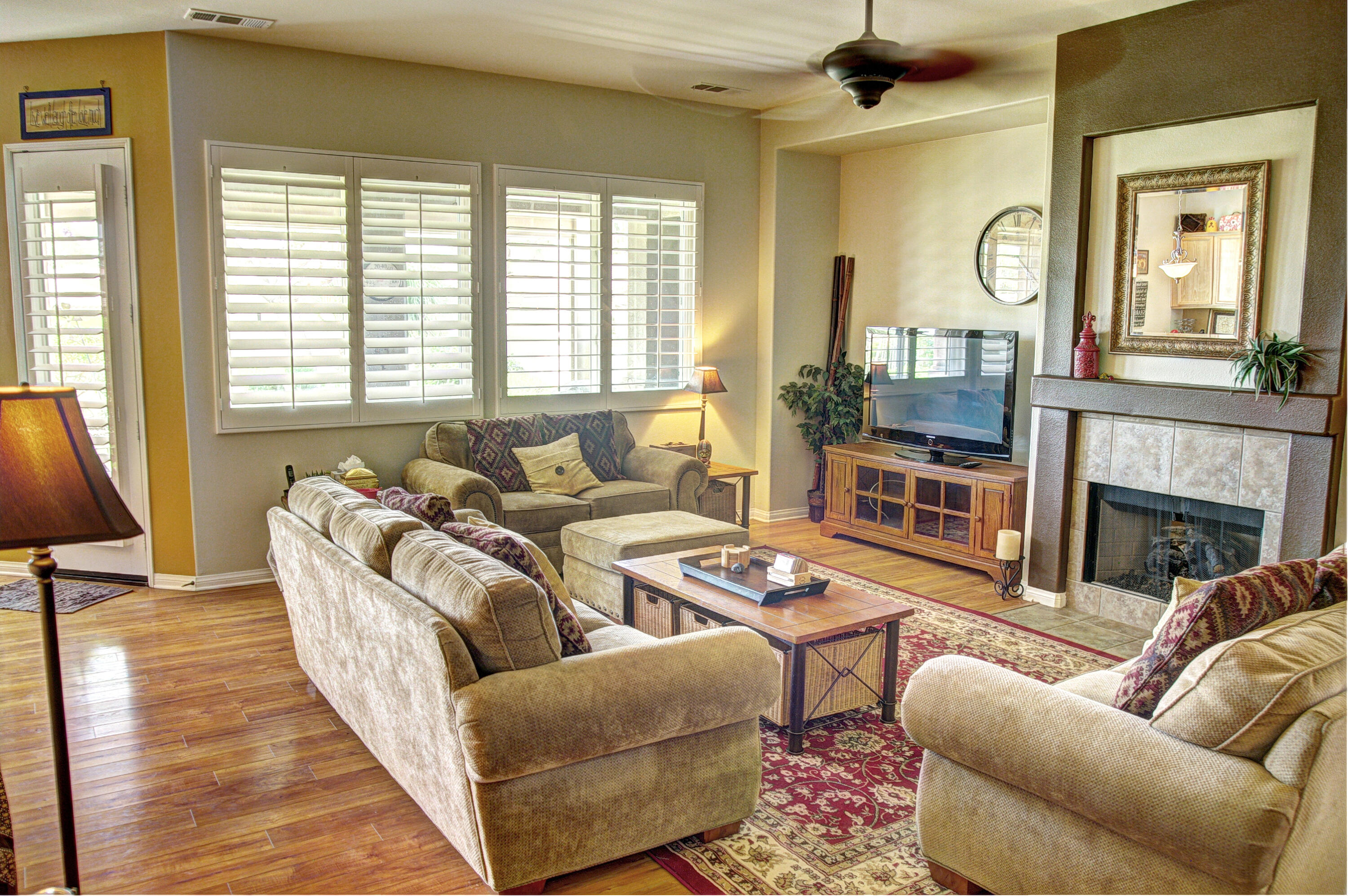 a living room with furniture fireplace and a large window