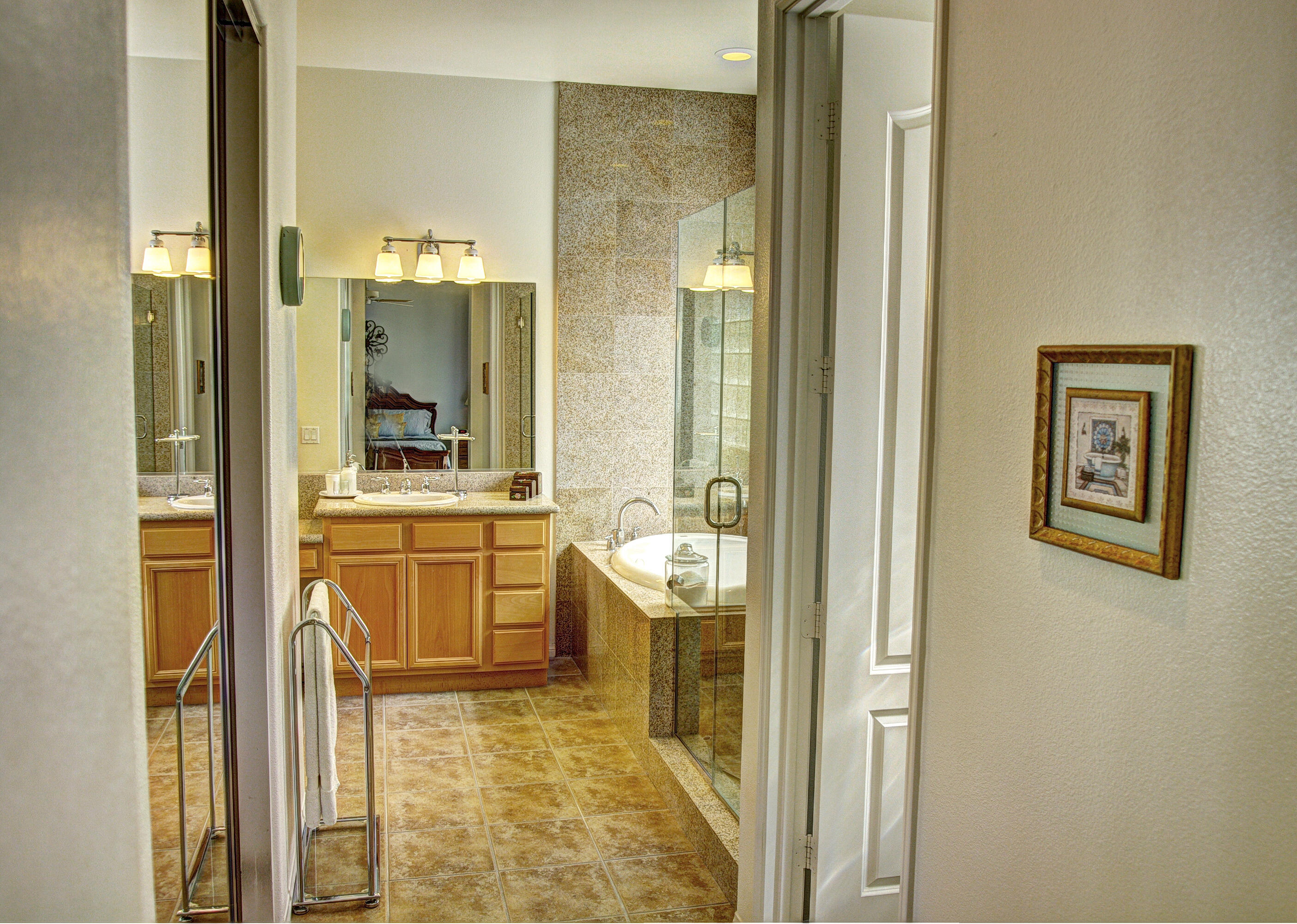 82799 Burnette Drive Indio, CA 92201 - Photo 19 of 36 a bathroom with a sink a mirror and a shower