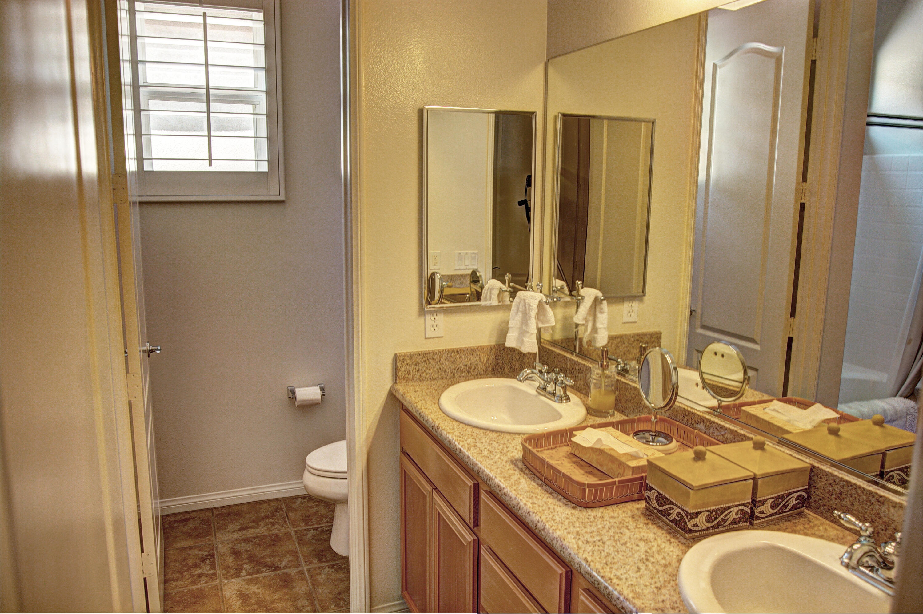 82799 Burnette Drive Indio, CA 92201 - Photo 23 of 36 a bathroom with a granite countertop double vanity sink mirror and toilet