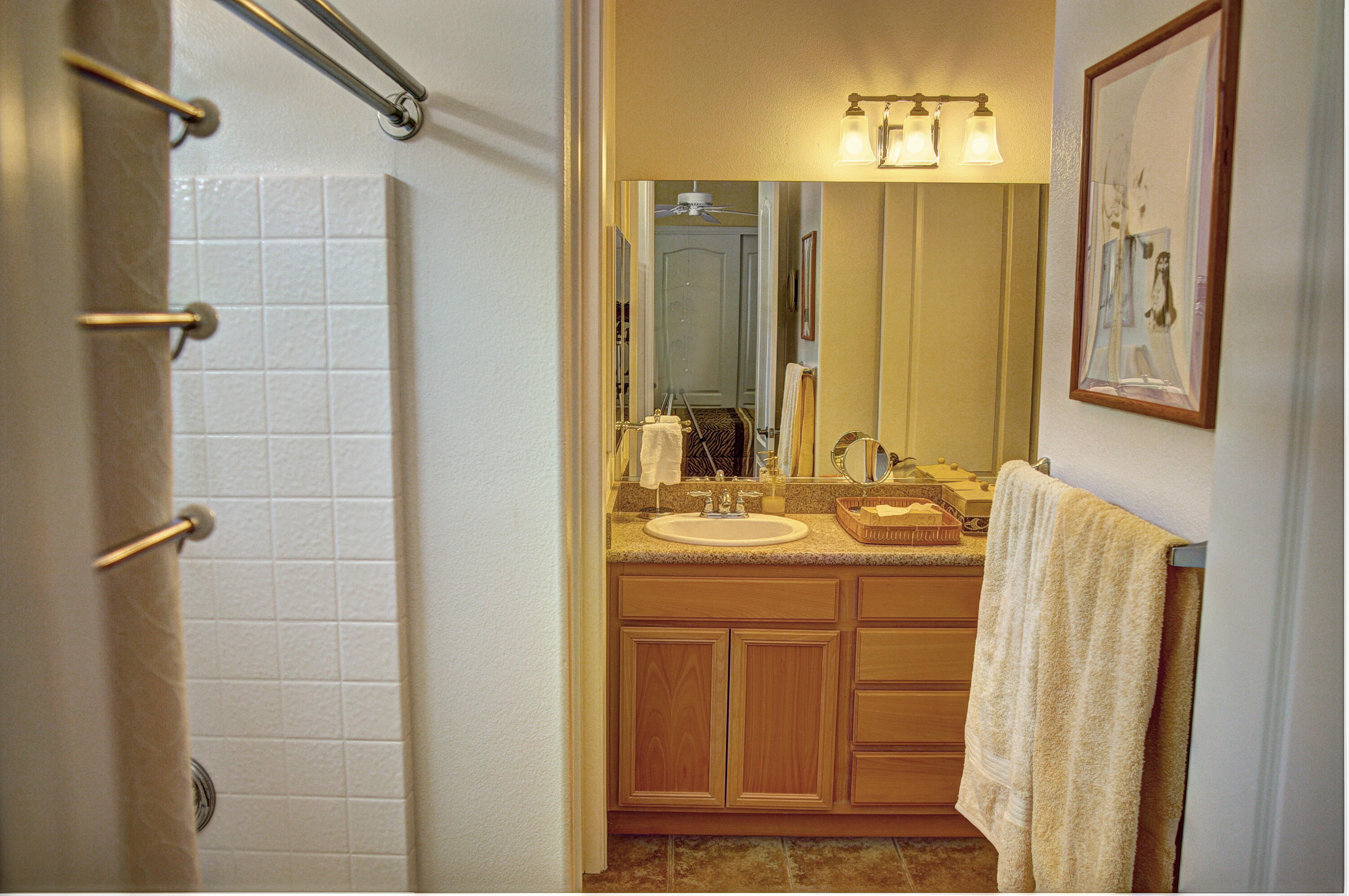 82799 Burnette Drive Indio, CA 92201 - Photo 24 of 36 a bathroom with a granite countertop sink and a mirror
