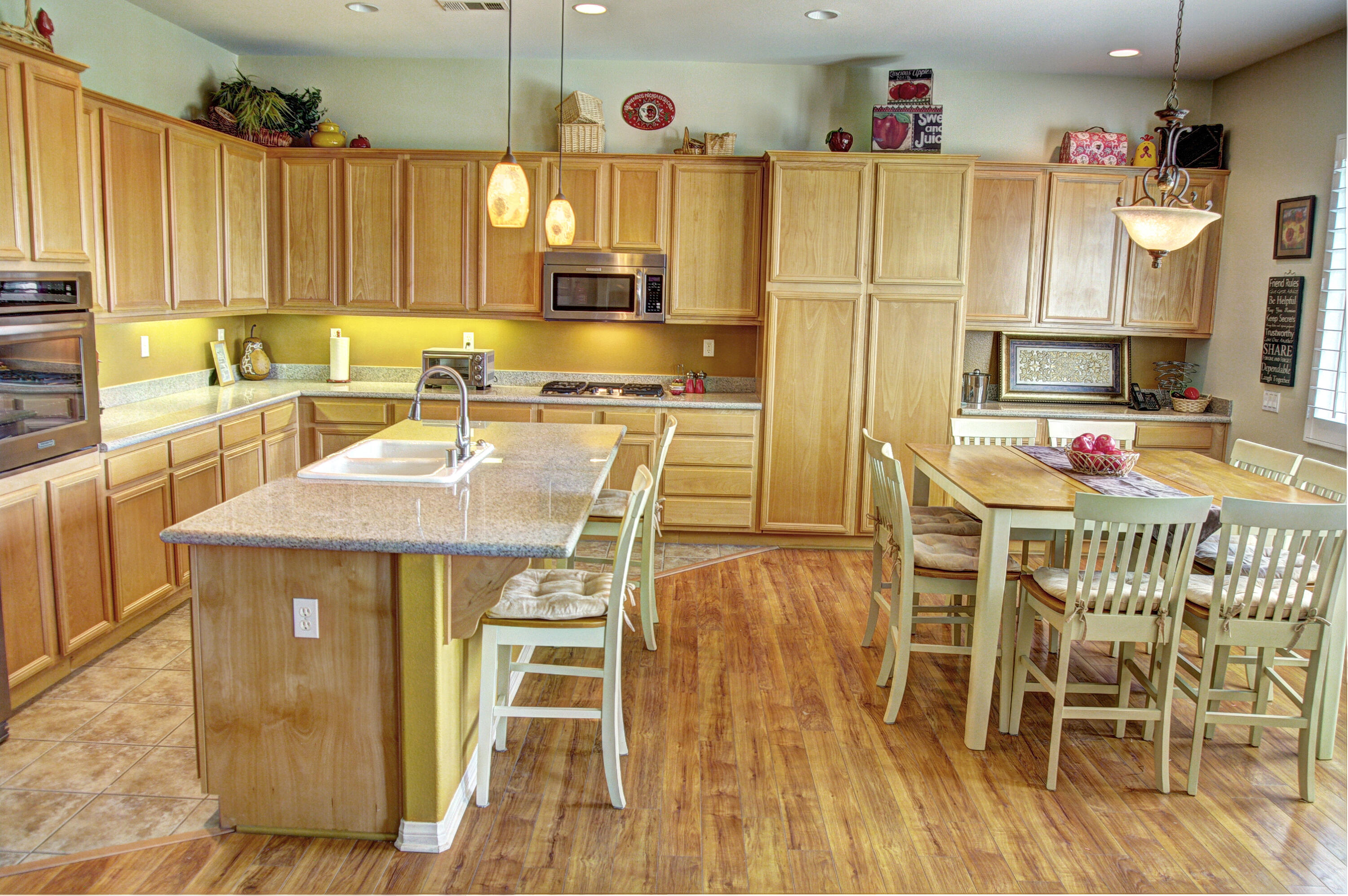 82799 Burnette Drive Indio, CA 92201 - Photo 3 of 36 a kitchen with stainless steel appliances kitchen island granite countertop a table chairs and a sink