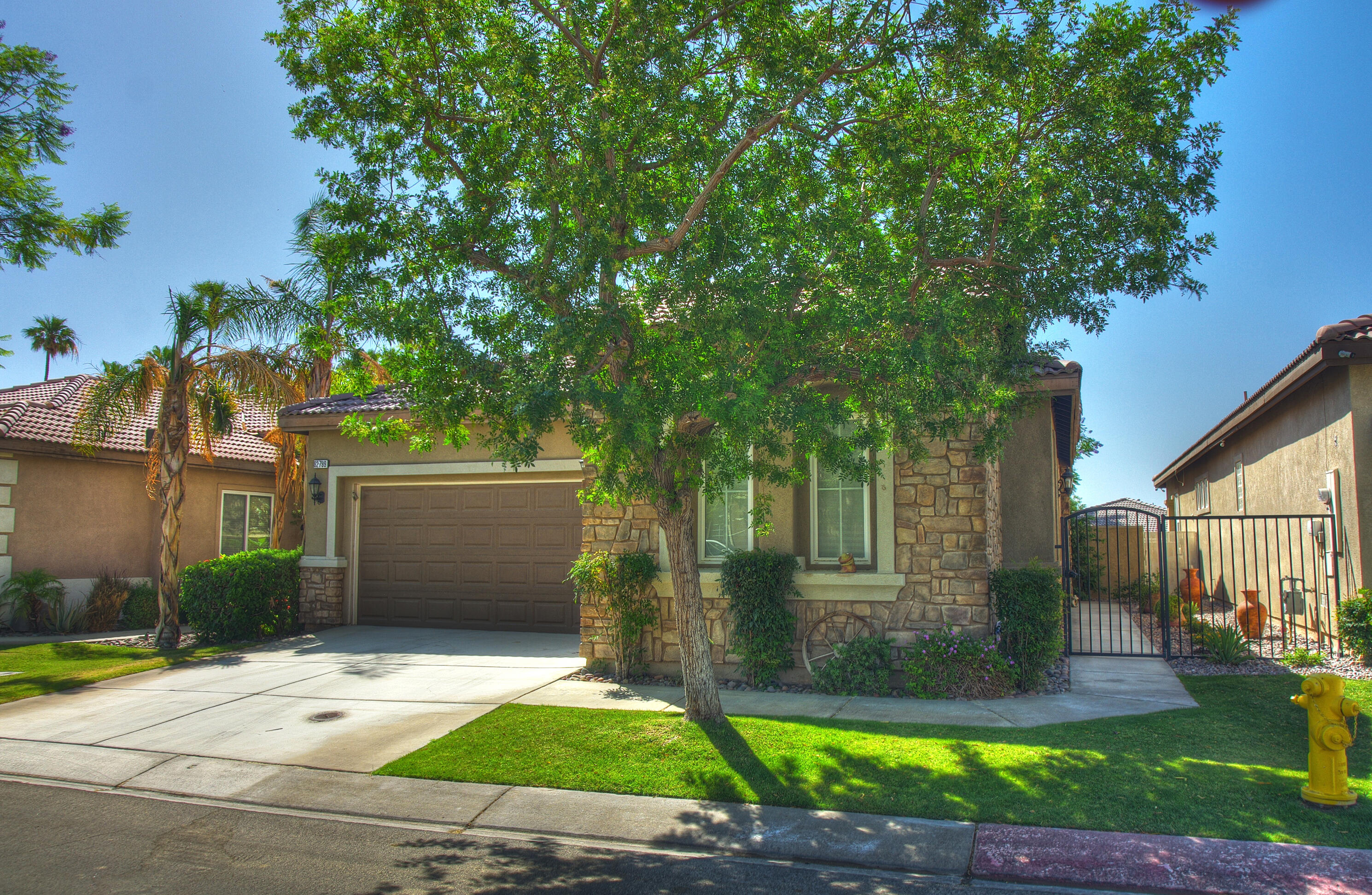 82799 Burnette Drive Indio, CA 92201 - Photo 36 of 36 front view of a house with a yard