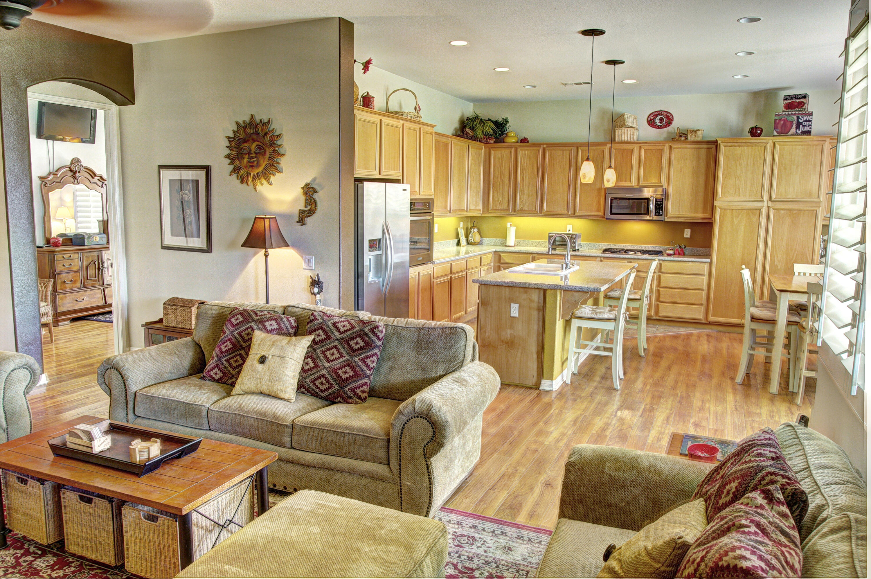 82799 Burnette Drive Indio, CA 92201 - Photo 7 of 36 a living room with furniture kitchen view and a wooden floor