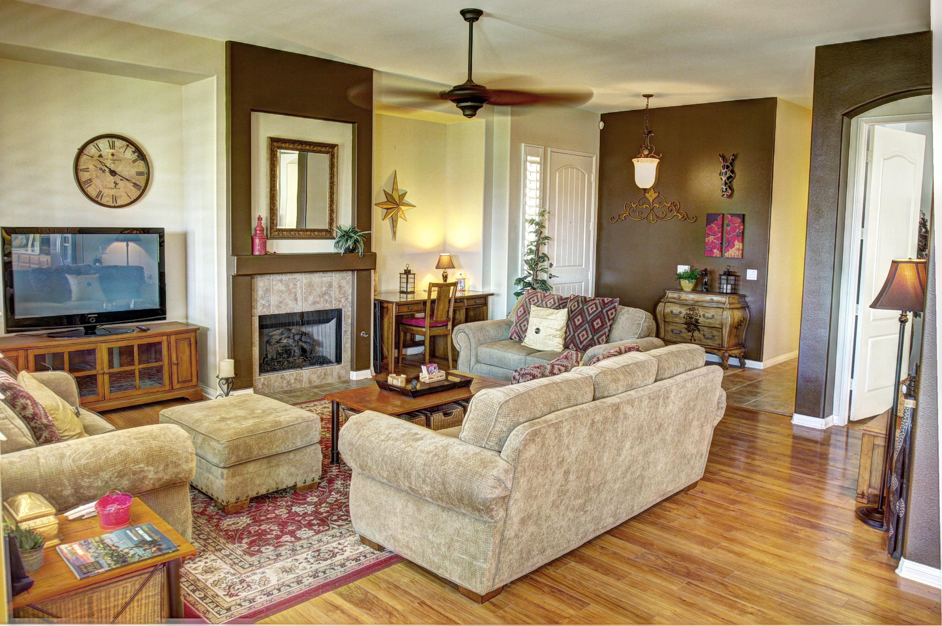 82799 Burnette Drive Indio, CA 92201 - Photo 8 of 36 a living room with furniture a fireplace and a flat screen tv