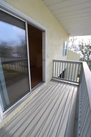 a view of balcony with wooden floor